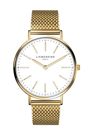 Gold Mesh-Uhrenarmband mit einem weißen Zifferblatt, goldenen Stundenmarkierungen und vier kleinen Kristallen. Hat ein minimalistisches Design und ein rundes Metallgehäuse.