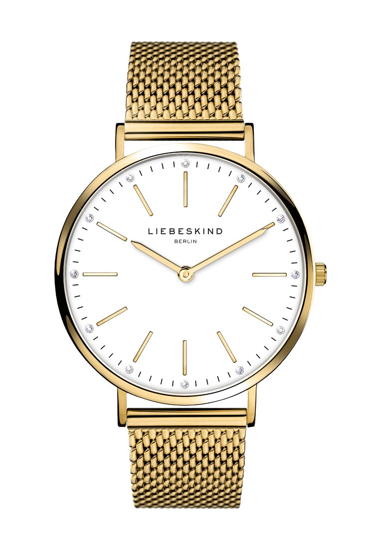 Gold Mesh-Uhrenarmband mit einem weißen Zifferblatt, goldenen Stundenmarkierungen und vier kleinen Kristallen. Hat ein minimalistisches Design und ein rundes Metallgehäuse.