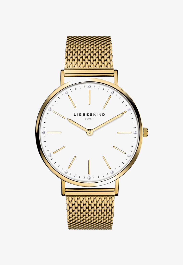 Gouden mesh horloge met een witte wijzerplaat, gouden uurmarkers en vier kleine kristallen. Het heeft een minimalistisch design en een ronde metalen behuizing.