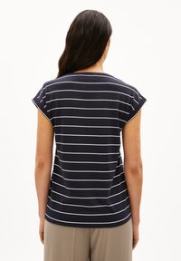Navy blue striped t-shirt with short rolled sleeves, a round neckline, and a straight hem, made from a soft fabric.