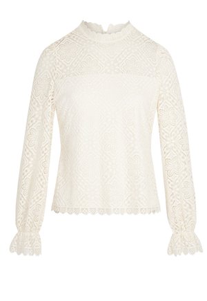 Top bianco in pizzo con maniche lunghe, scollatura ondulata, motivo floreale e polsini arricciati, caratterizzato da un design trasparente e testurizzato.