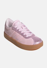 Pink suede sneakers with a shiny pink toe cap and three vertical stripes. Features a gum sole and textured accents on the upper.