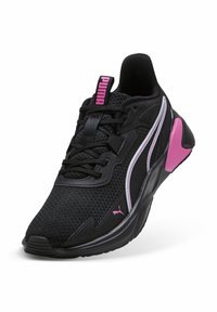 Pantofii sport negri cu partea superioară din plasă, accente roz, branding proeminent, design al tălpii curbate și șireturi tonale.