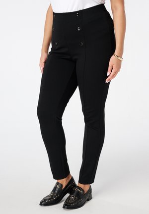 Pantalons noir taille haute en tissu extensible, dotés d'un design élégant avec des boutons dorés décoratifs et une coupe slim le long des jambes.