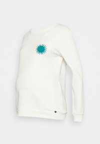 Sweat-shirt de maternité blanc avec un graphisme en forme de rayon de soleil teal sur la poitrine. Il présente des manches longues, un tissu doux et un petit accent marron au niveau de l'ourlet.