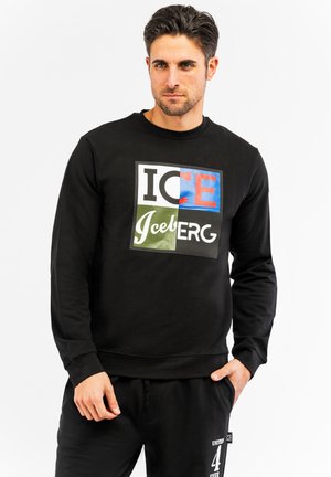 Sudadera negra con un gráfico frontal colorido que dice "ICE IceBERG." Tiene un cuello redondo clásico y puños acanalados. Material de mezcla de algodón.