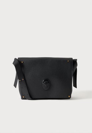 Black textured leather shoulder bag with adjustable strap, gold studs on corners, and embossed emblem on front flap.