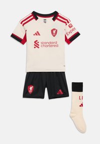 Cream and red Liverpool FC jersey with black shorts and cream socks featuring club logos and Adidas branding.