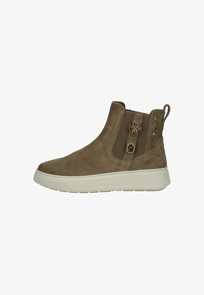 Suede ankle boot in brown with elastic side panels, featuring jewel accents and a white sole. Smooth texture and rounded toe design.