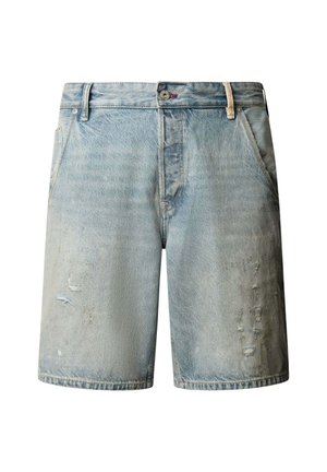 Helesinised teksapüksid, millel on kulunud detailid, esimesed taskud, vööaasad ja nööpkinnitus.