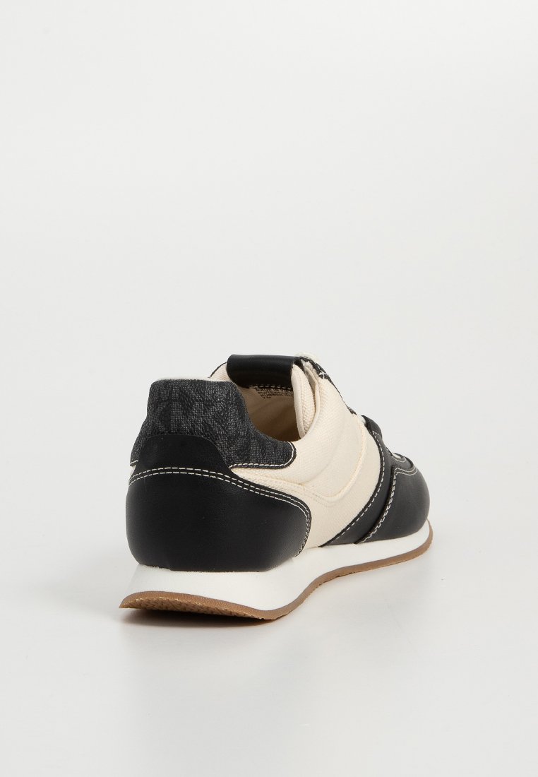 Svart och krämfärgad retro-stil sneakers med en texturerad baksida, släta läderdetaljer, vita sömmar och en brun gummisula.