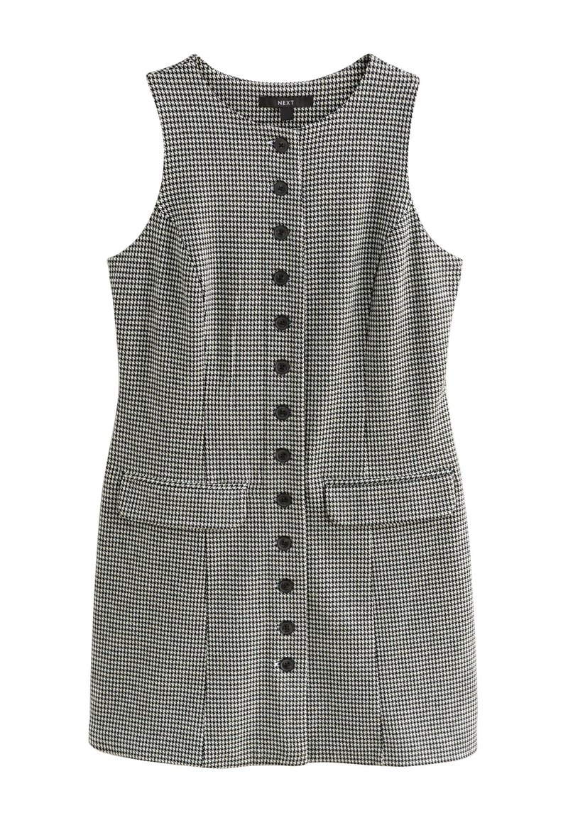 Abito senza maniche in pied de poule bianco e nero con scollatura rotonda, chiusura frontale con bottoni e due tasche laterali.