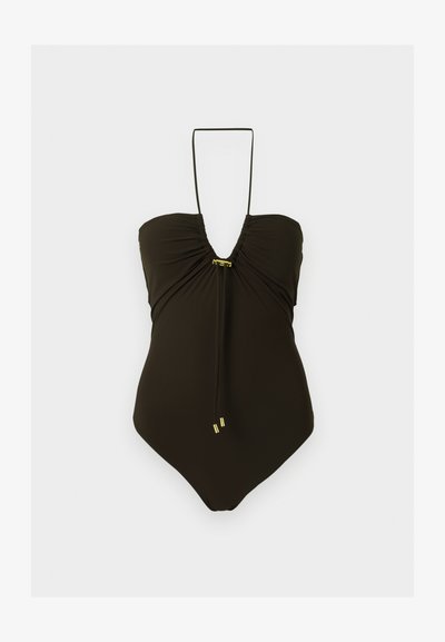 Μαύρο ολόσωμο μαγιό με δέσιμο στον λαιμό, συγκεντρωμένη λεπτομέρεια στο στήθος και μικρές μεταλλικές χρυσές πινελιές στο κέντρο και στα άκρα των δεσίμάτων.