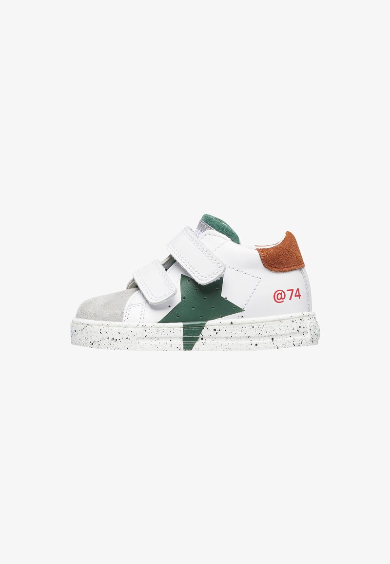 White sneaker with grey and green accents, two Velcro straps, and a brown suede heel. Features a green star design and speckled sole.