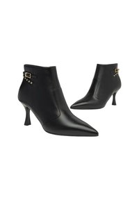 Stivali alla caviglia in pelle nera con punta appuntita e tacco di 2,5 pollici. Presentano una fascia decorativa e borchie dorate sui lati.