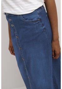 Denim rok in blauw met een knoopsluiting aan de voorkant, met een zijzak en subtiele stikdetails. Vrolijke vorm met een middellange snit.