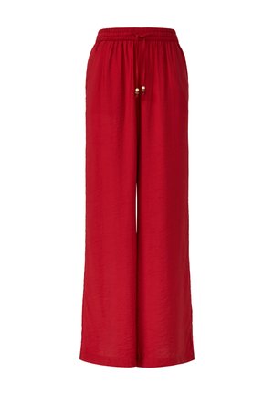 Pantalons larges rouges en tissu texturé. Équipés d'une taille élastique avec un cordon de serrage et des perles décoratives.