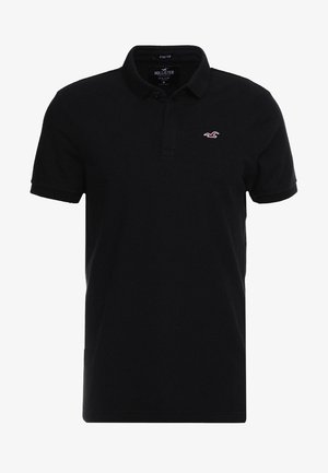 Schwarzes kurzärmeliges Poloshirt mit Kragen, Zwei-Knopf-Leiste und kleinem weißen Möwenlogo auf der linken Brust.
