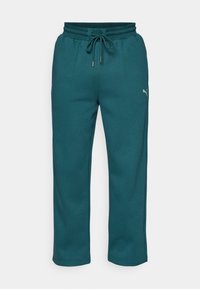 Teal sweatpants lavet af et blødt, struktureret stof. Har en elastisk talje med snørelukning og sidelommer. Logo accent på benet.