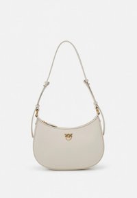Cream-colored leather handbag with a curved shape, adjustable strap, and gold-tone hardware featuring a logo accent. Smooth texture.