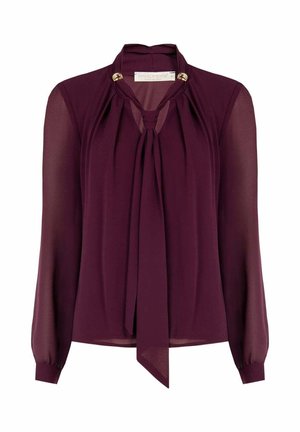 Blusa color bordeaux in chiffon leggero con maniche lunghe, dettaglio con fiocco al collo e accenti dorati sul colletto, dal design fluido.