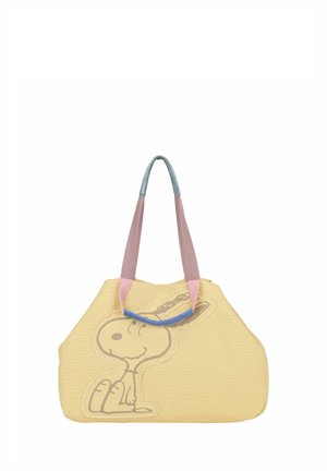 Sac cabas souple jaune avec des poignées roses et bleues, présentant un contour cousu d’un chien de dessin animé assis à l’avant.