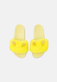 Yellow fluffy slide sandals with a soft textured strap and golden ear accents. The sole is smooth and light yellow.