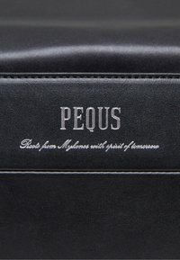 Svart lærprodukt med preget "PEQUS"-logo og dekorativ tekst. Glatt tekstur med hvite sytråder langs kanten.