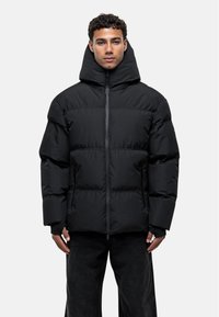 Black puffer jacket with a high collar and zip closure, featuring a quilted design, matte texture, and side pockets.