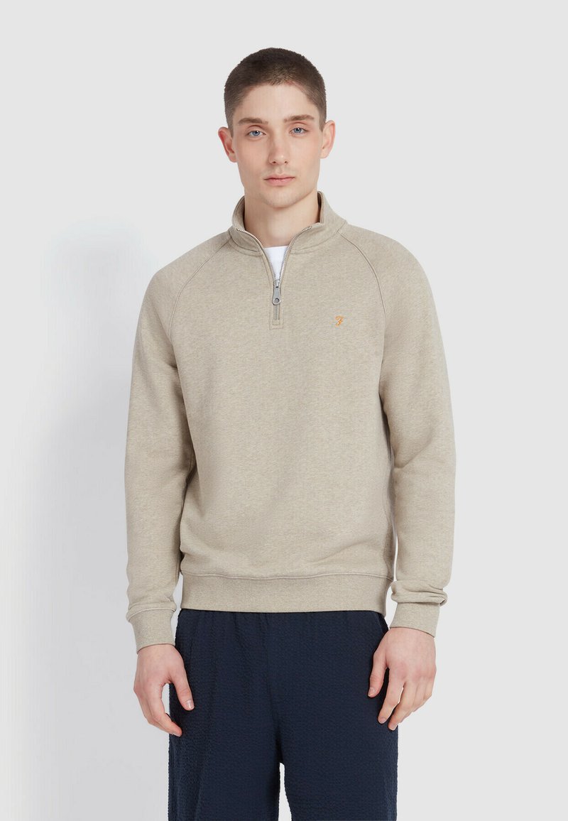 Beige fleece pullover met een ritskraag, raglanmouwen en een klein logo op de borst. Gladde textuur en een ontspannen pasvorm.