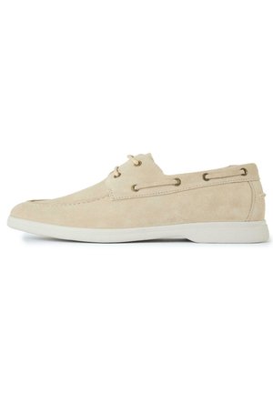 Beige suede casual boat shoe with white rubber sole and lace detail, shown from the side on a white background.