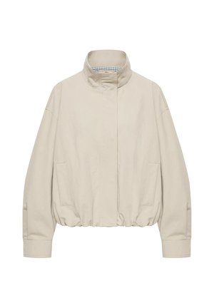 Beige jakke med høj hals, lange ærmer, skjult frontlukning, elastisk kant og to sidelommer, vist på hvid baggrund.