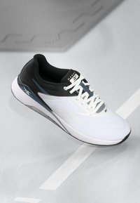 White athletic shoe with a black heel and grey accents. Features a textured upper, padded collar, and contrasting laces for secure fit.