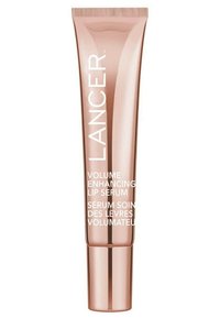 Rose gold tube packaging for a lip serum with white text. Features a smooth texture and rounded cap. Labels include English and French.