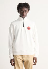 White quarter-zip sweatshirt with ribbed cuffs and hem, featuring a circular red logo labeled "HUGO" on the left chest area.