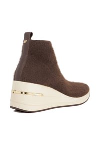 Brown, fuzzy ankle boots with a sleek beige wedge sole. Features a gold accent on the heel and a smooth leather back panel.