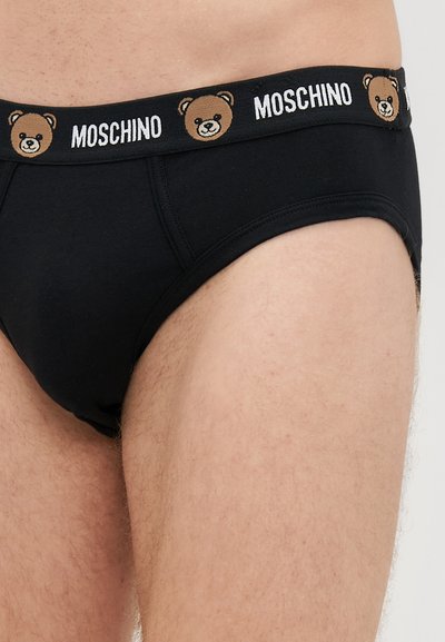 Črne bombažne hlačke z elastičnim pasom, ki ima odtis medveda, nudijo nekonflikten oprijem in mehkobo.