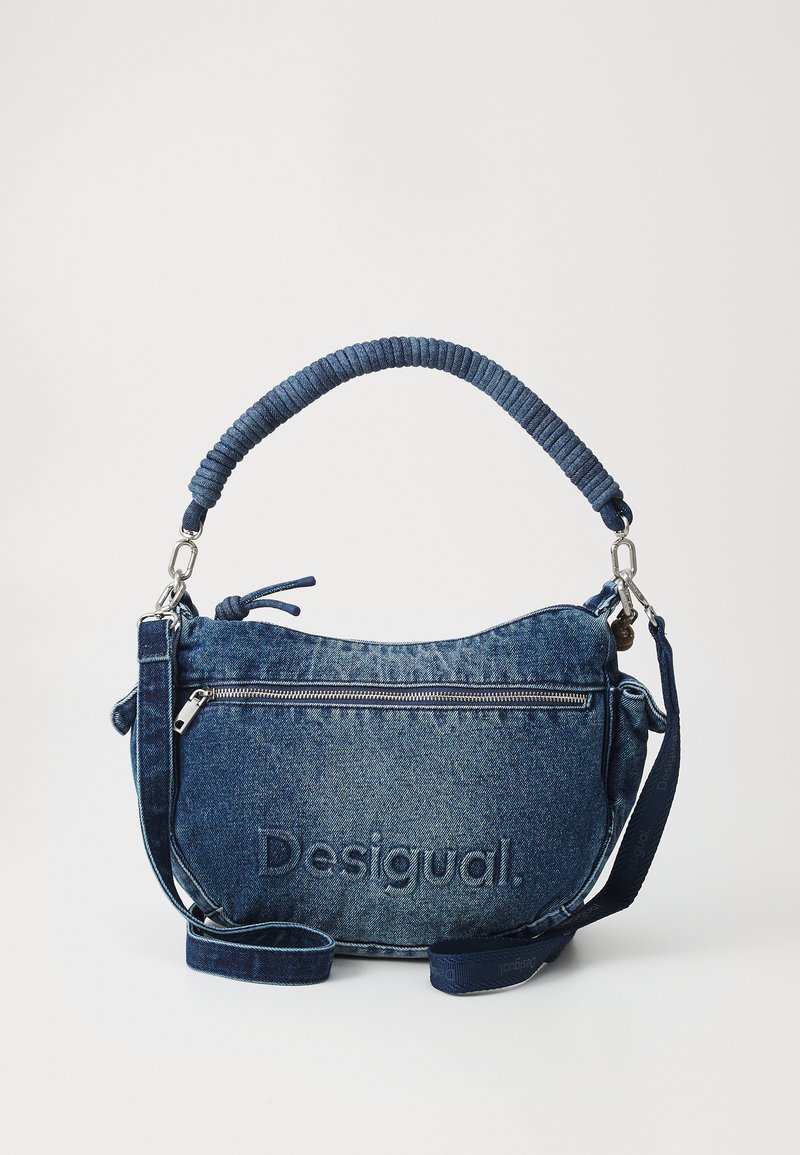 Denim handbag with a textured, blue material. Features a looped handle, adjustable strap, front zip pocket, and embossed brand name.