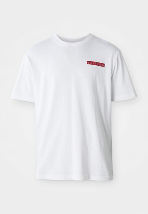 T-shirt en coton blanc avec un col rond, des manches courtes et un petit détail graphique rouge sur la zone de la poitrine gauche.