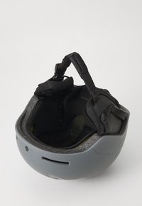 Gray helmet with a smooth exterior, adjustable black straps, padded interior, and ventilation holes. Features a textured, soft lining.