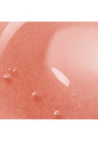 Gel rosa traslucido e scintillante, con finissima glitter dorata e piccole bolle, caratterizzato da una texture liscia e una superficie riflettente.