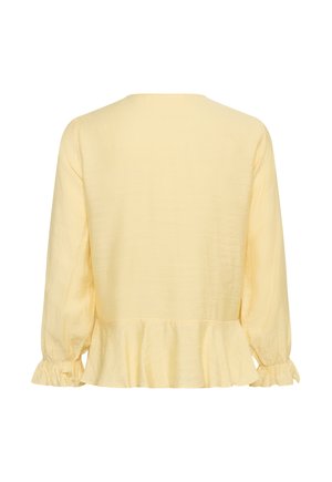 Blouse jaune pâle à manches longues avec poignets volantés et ourlet peplum, vue de dos sur fond blanc.
