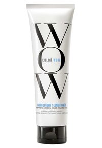 Vit plastkapsel med djärv svart och blå text. Innehåller "Color Wow Color Security Conditioner" för färgbehandlat hår. Svart kork, slank design.