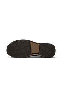 Sole of a black shoe with textured grip patterns and a brown rectangular insert labeled "Xsensible Stretchwalker" in the center.