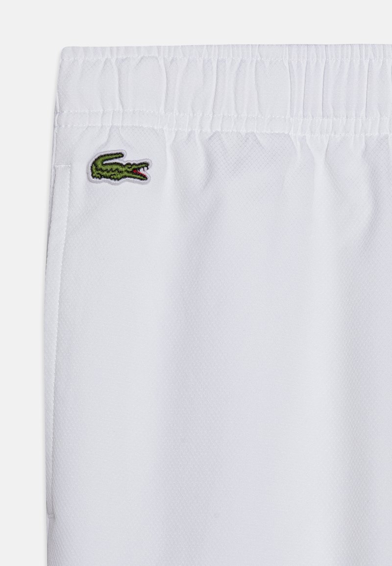 White lacoste trousers Clearance