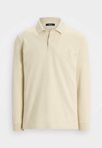Beige långärmad polo-tröja med krage, två knappar, ribbade cuffs och liten vit broderad logotyp på vänster bröst.
