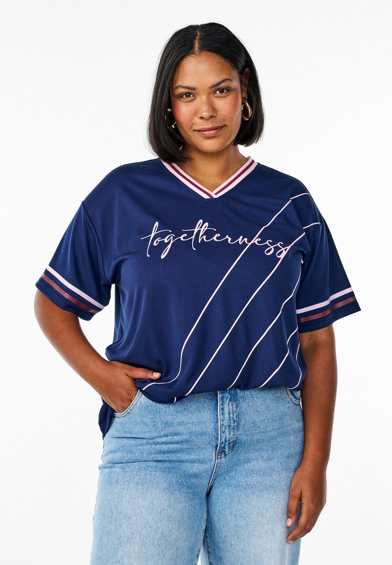 Navy blue athletic-style t-shirt with short sleeves, v-neck, pink accents, and white text "togetherness" and diagonal stripes. Denim jeans.