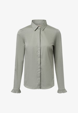 Svijetlozelena košulja dugih rukava od glatkog materijala. Ima klasičnu kragnu, prednje kopčanje na gumbe i nabranice na manžetama rukava.