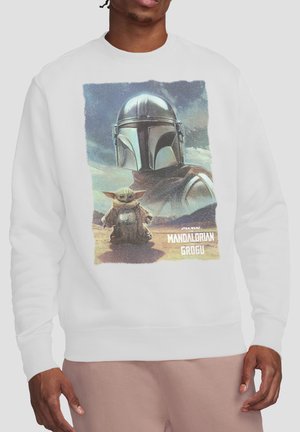 White sweatshirt with graphic of Mandalorian helmet and Grogu standing on desert ground, with "Star Wars Mandalorian and Grogu" text.
