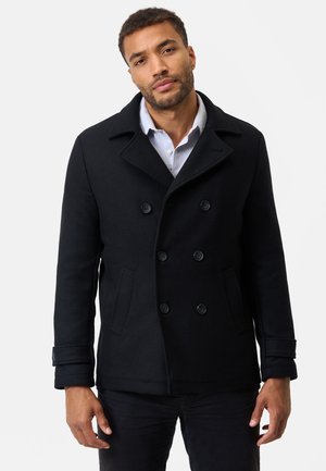 Black wool peacoat featuring double-breasted front, large buttons, and side pockets; classic collar and cuff detailing.